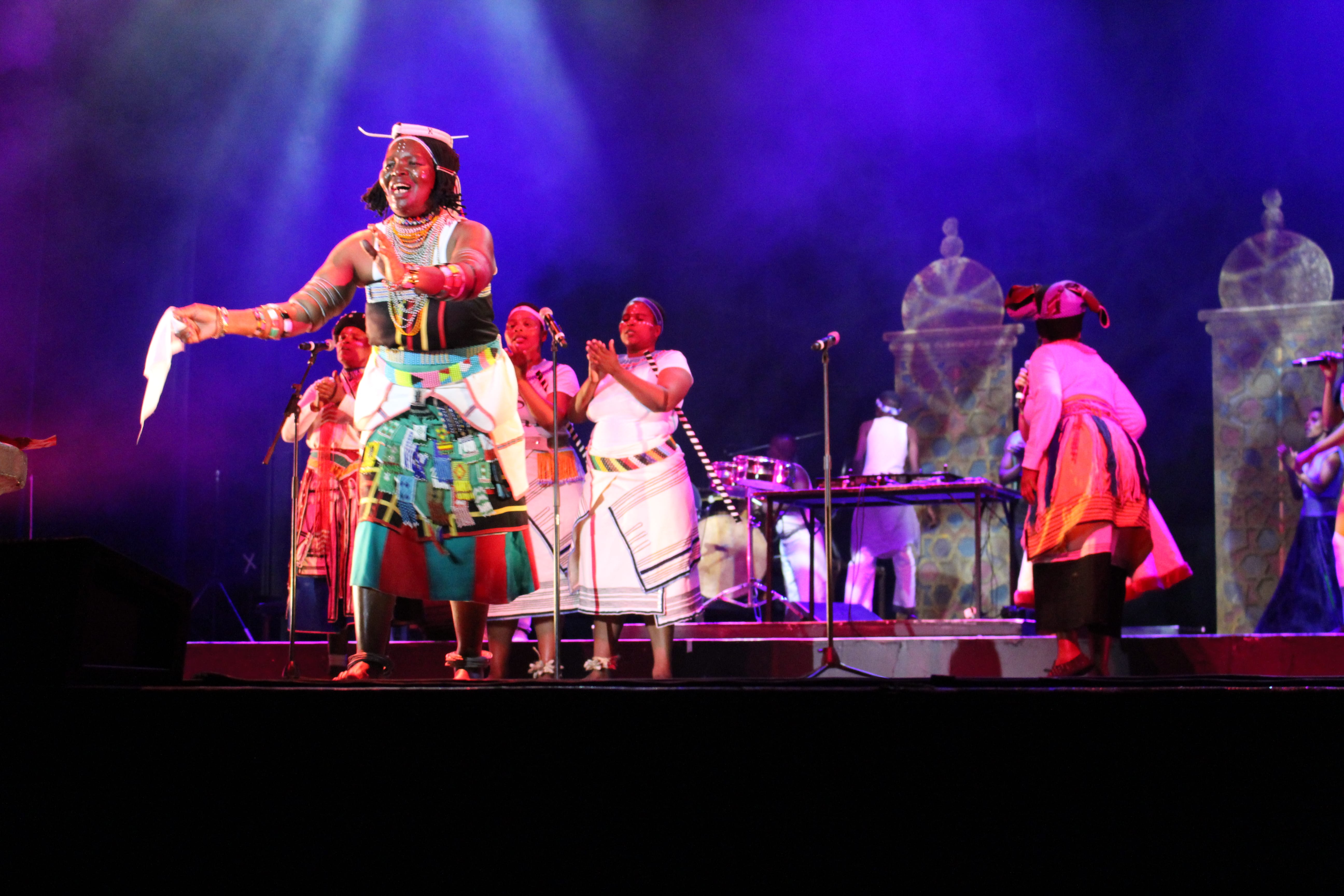  an image of an african elderly woman on the stage performing at an african event in berlin